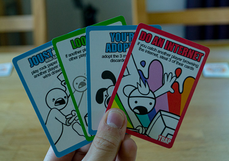 A hand holding 4 cards.